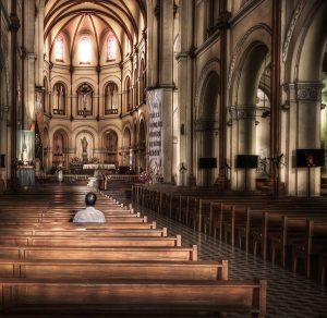 man-praying-in-church